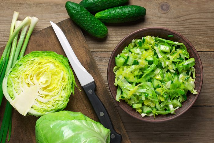 Green vegetable salad of cabbage, cucumbers and spring onion in bowl