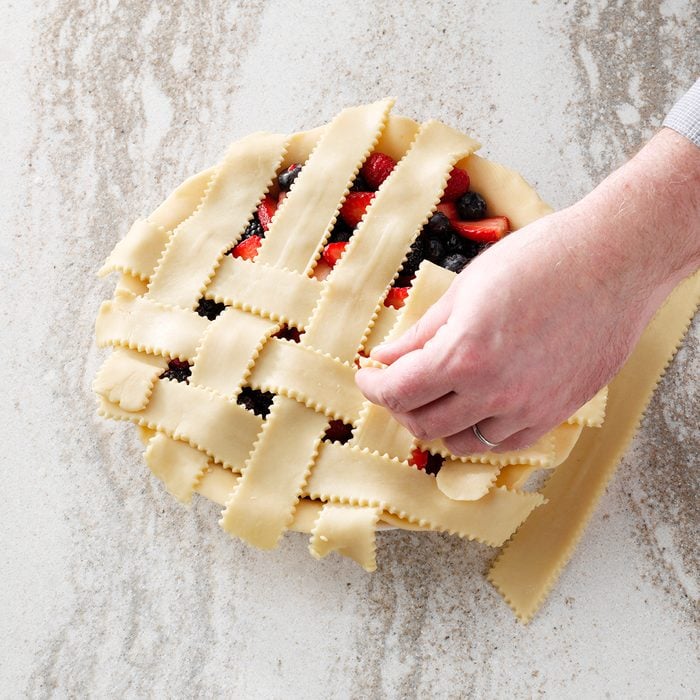 Weaving the lattice strips on top of a pie