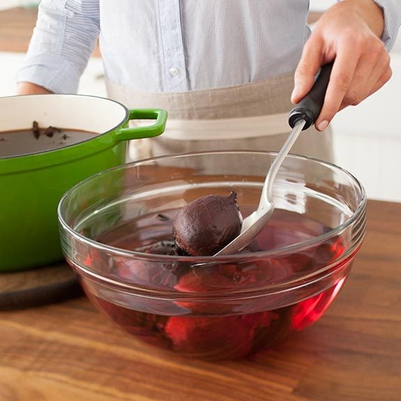 Remove beets to a bowl of cold water.
