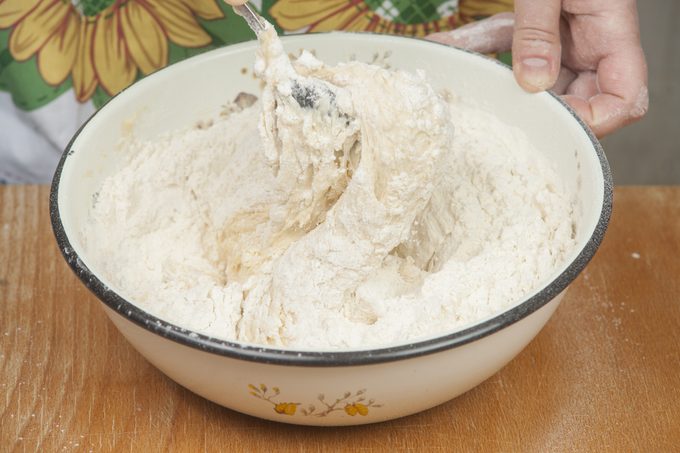 Woman's hands showing how to make pizza dough