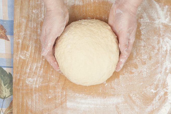 Ball of pizza dough with flour