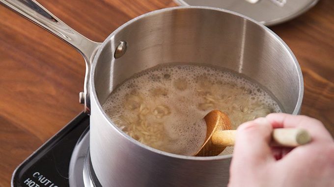 rice simmers on the stove top in a metal pot