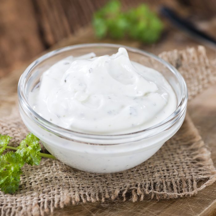 Sour Cream with fresh herbs (close-up shot) on wooden background; Shutterstock ID 386894842; Job (TFH, TOH, RD, BNB, CWM, CM): Taste of Home