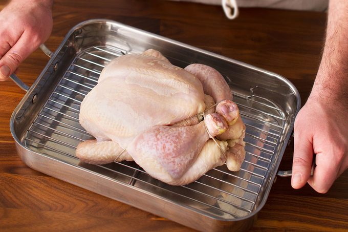 Raw chicken on a roasting rack