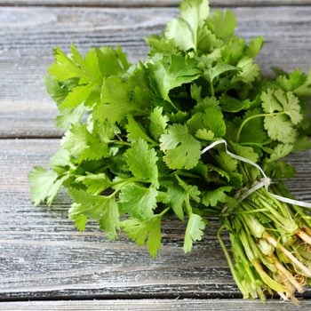 bunch of fresh cilantro on the boards, fresh herbs; Shutterstock ID 230800417