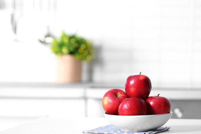 Bowl of fresh red apples on kitchen counter