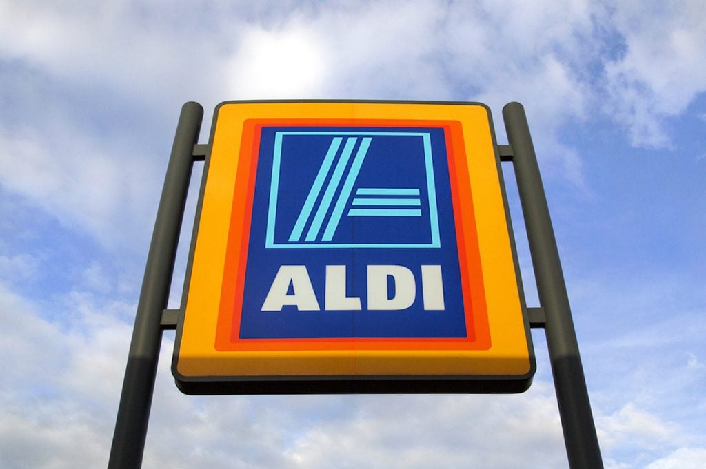 Swansea, UK: May 2016: Commercial sign of ALDI Store against a blue sky. ALDI is a large discount supermarket chain with app. 4200 stores in Germany. It specializes in lower priced products.