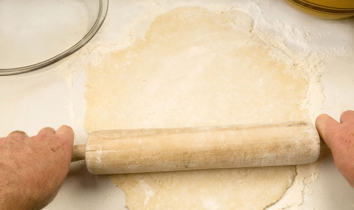 old-fashioned pie baking - rolling the dough