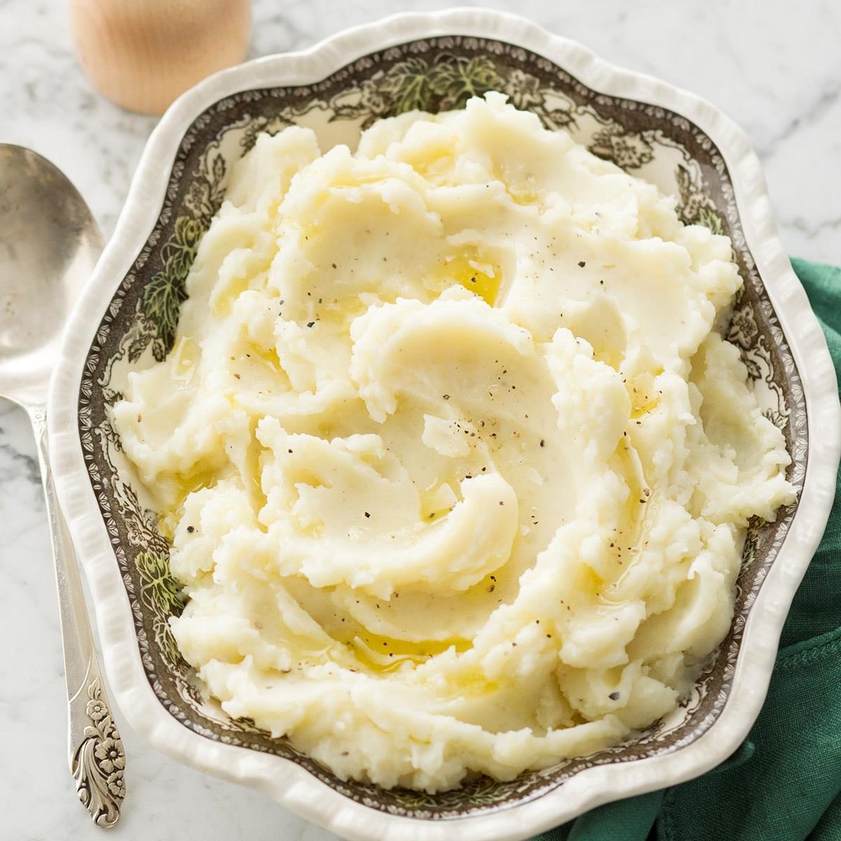 Large white plate filled with buttery mashed potatoes