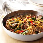 A skillet with Beef & Spinach Lo Mein