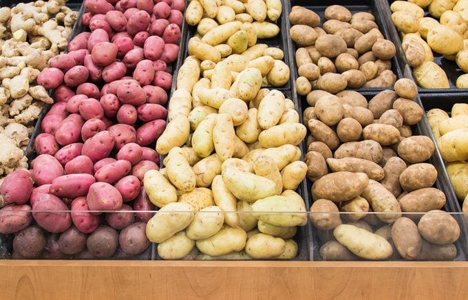 Different varieties of potatoes in a shelf in a grocery store
