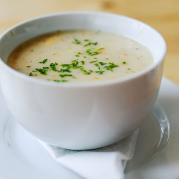Garlic soup on a wooden table in a restaurant.