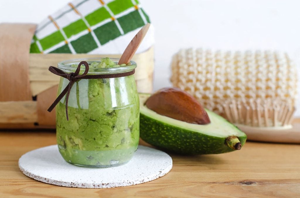 Homemade avocado mask in a glass jar.