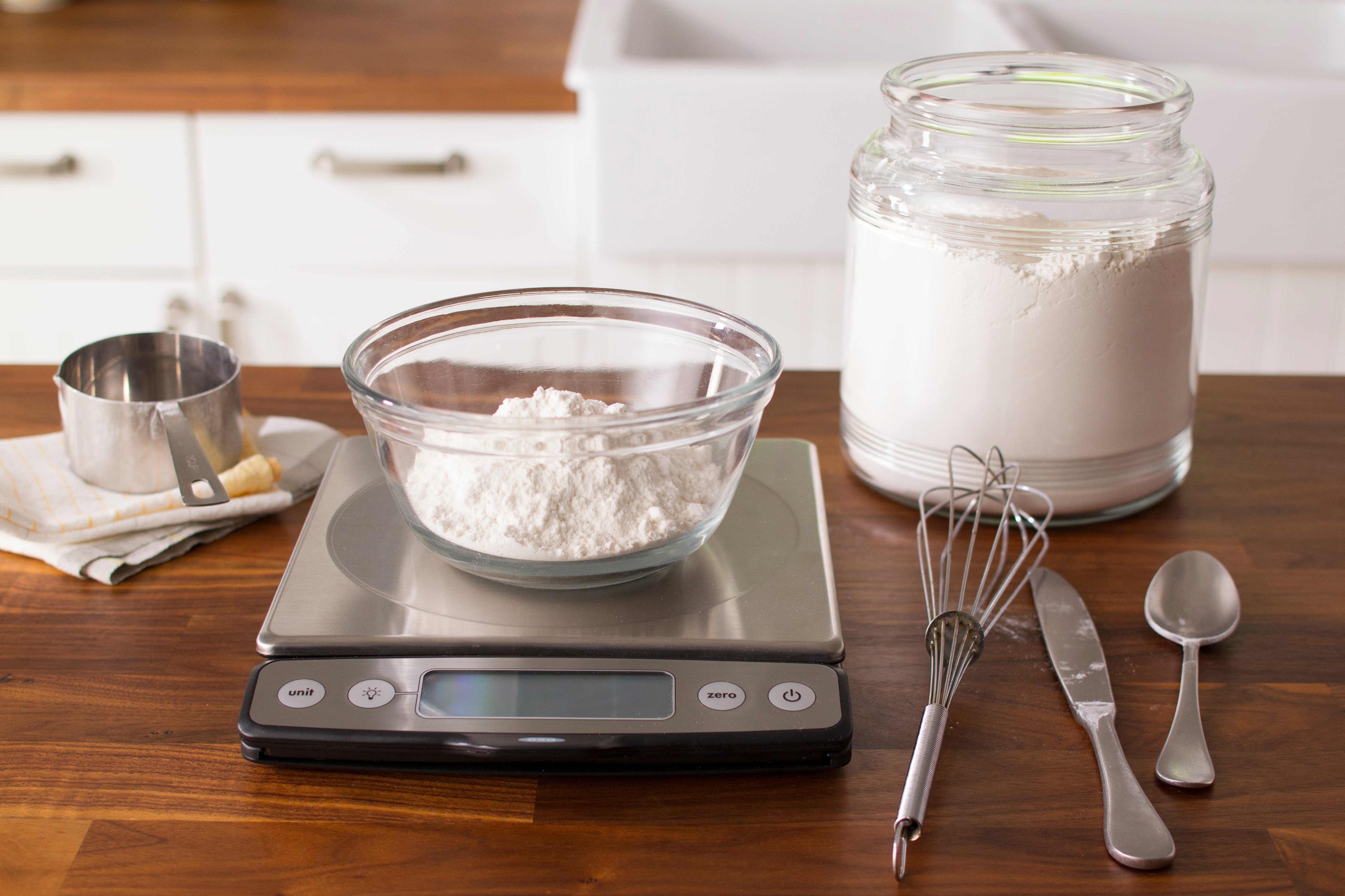 Measuring Flour Into Kitchen Scales Stock Photo, Picture and
