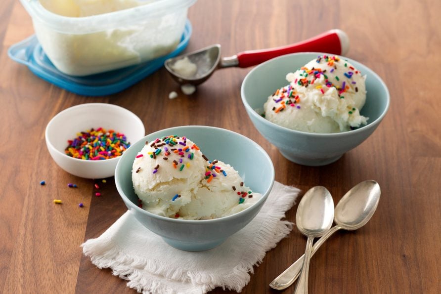 Frozen vanilla yogurt in a dish and topped with colorful sprinkles