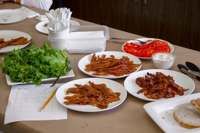 Plates of unmarked bacon sitting on a table ready for testing