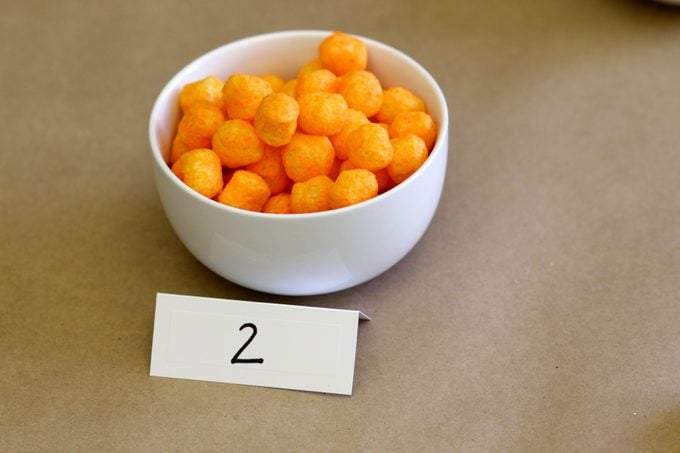 Bowl with the number 2 filled with cheese puffs