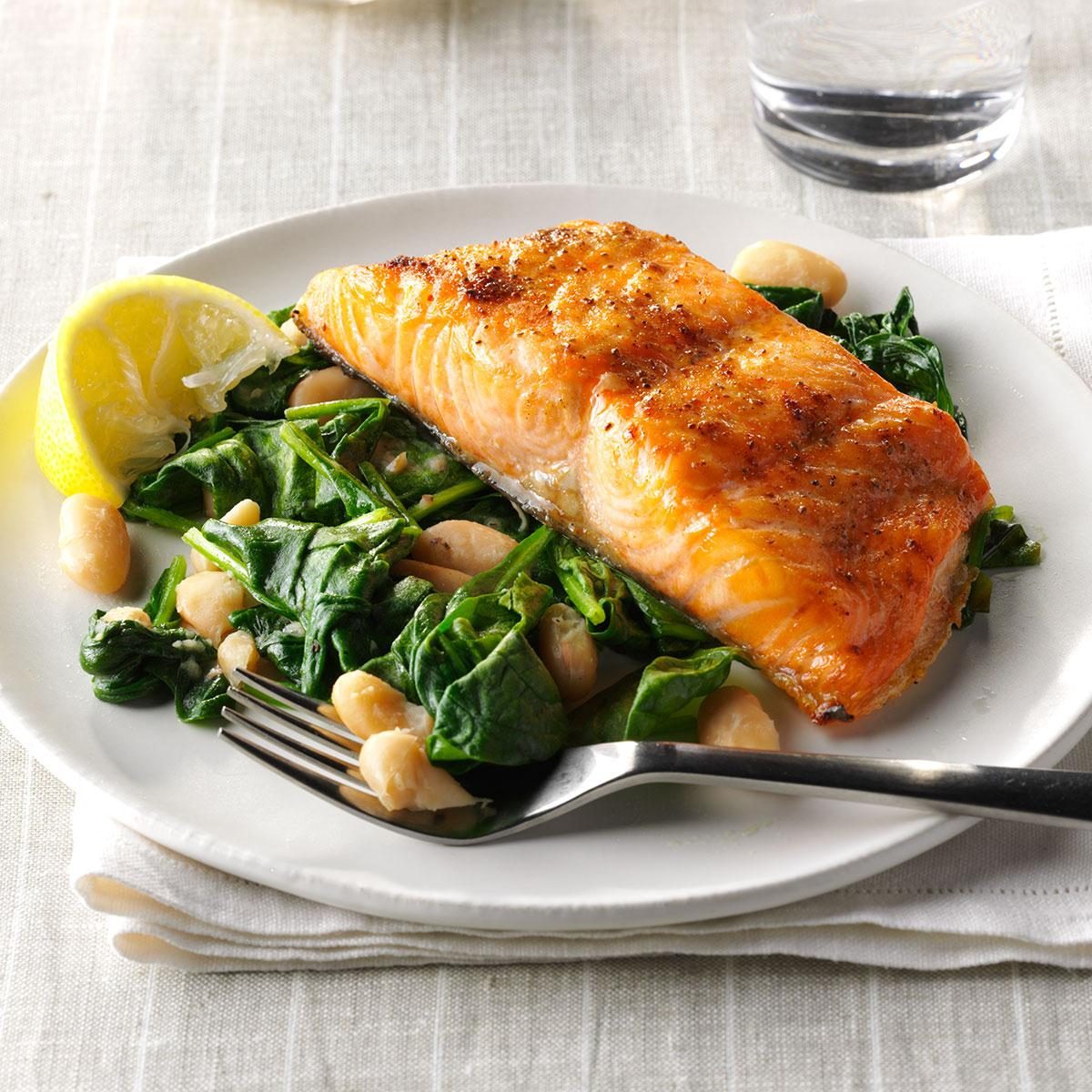 Broiled salmon with spinach and white beans.