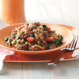 Sausage risotto with spinach and tomatoes