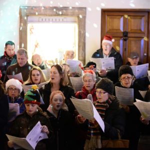 People sing carols at the Christmas Market in the streets surrounding Bath Abbey