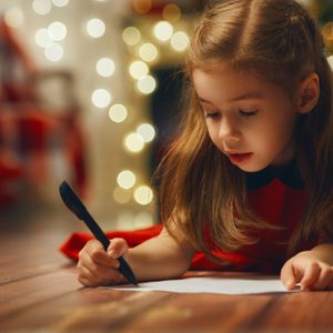Small child writes the letter to Santa