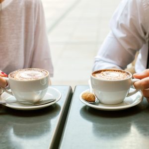 A man and woman with a cappuccino