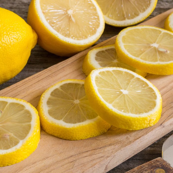 Lemon slices on the old wooden table.; Shutterstock ID 585968516
