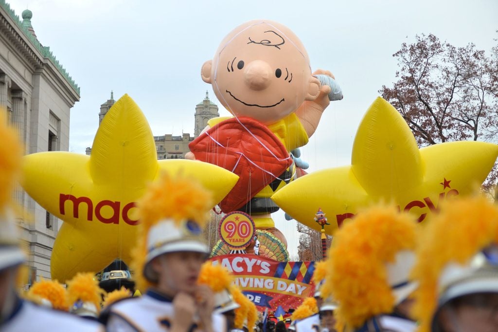 Marching bands and the Charlie Brown balloon at the start of the Macys Thanksgiving Day parade.