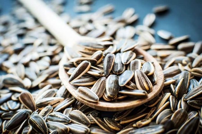 Hulled sunflower seeds in a wooden spoon