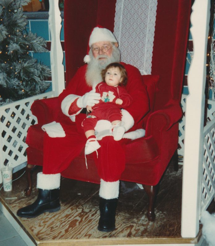 Young child sitting on Santa's lap