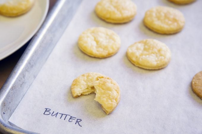 Pie crust with butter taste test - cookie-shaped pieces shown on a baking sheet labeled with "butter"