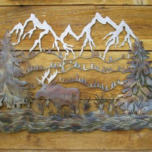 Close-up of metal on wood artwork of a moose in a river