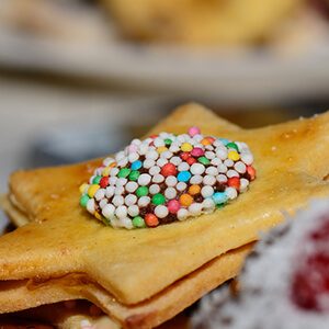 christmas cookie in star shape and sweet little colorful balls