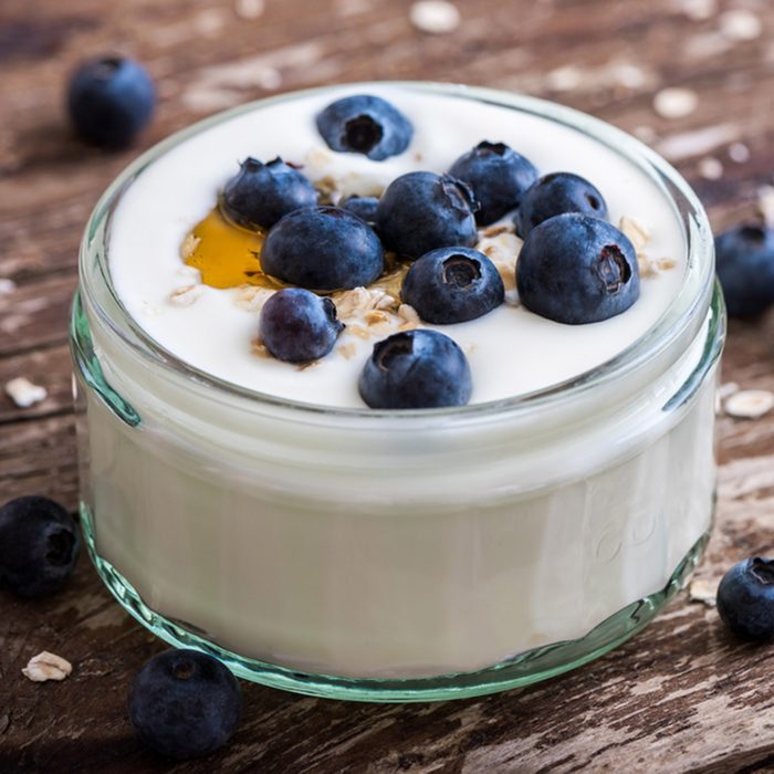 Serving of Yogurt with Whole Fresh Blueberries and Oatmeal on Old Rustic Wooden Table. Closeup Detail.; Shutterstock ID 298272557