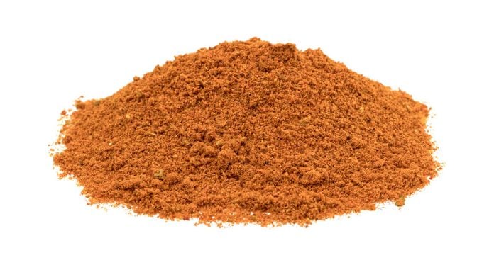 A small pile of taco seasoning isolated on a white background.