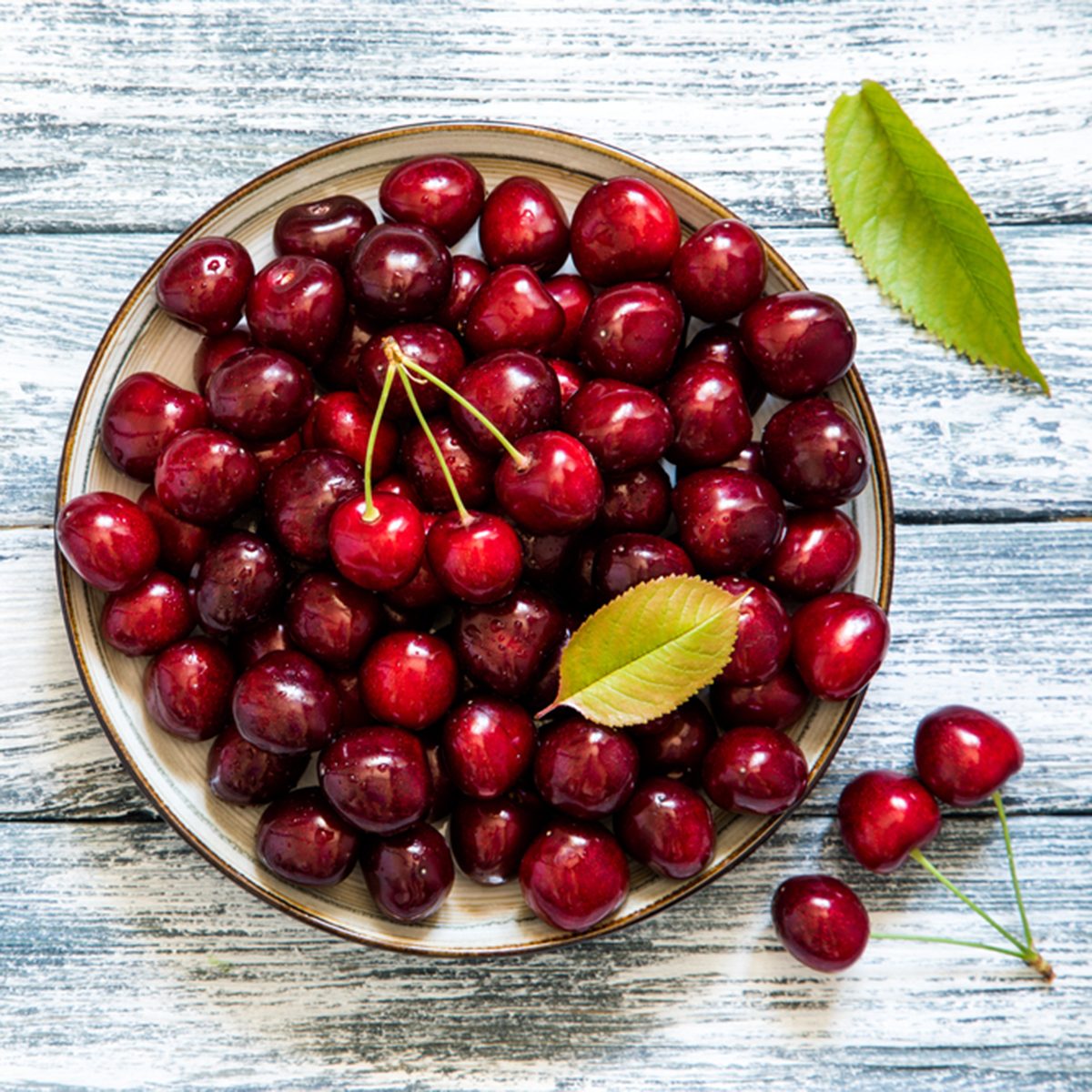 Fresh cherry on plate on wooden blue background. fresh ripe cherries. sweet cherries.; Shutterstock ID 663273784