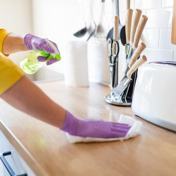 woman wiping counter top