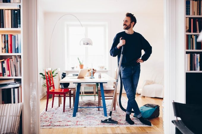 man standing in his clean living room