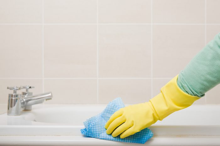 Person Cleaning Bathroom