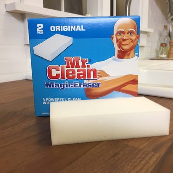 Mr. Clean magic eraser beside its packaging on a countertop