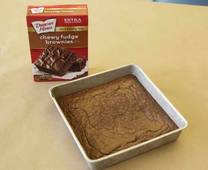 Duncan Hines brownies in a pan beside its packaging