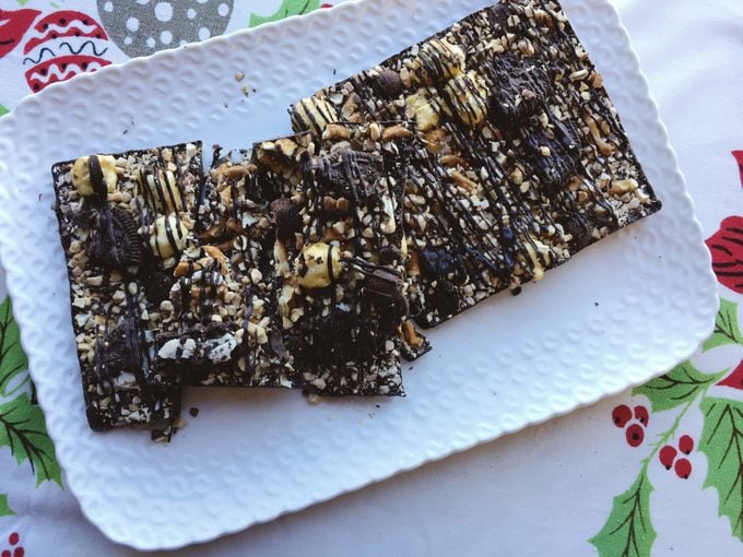Delicious bark with dark chocolate topped with almonds, pretzels, caramel corn and mini peanut butter cups