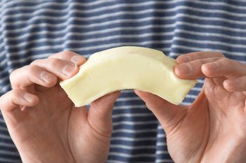 Image of person bending softened butter.