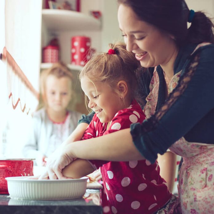 Mother and daughter baking together