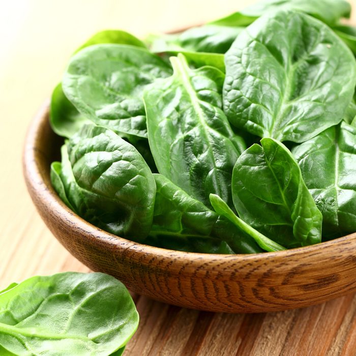 Young spinach in a wooden plate; Shutterstock ID 127762526