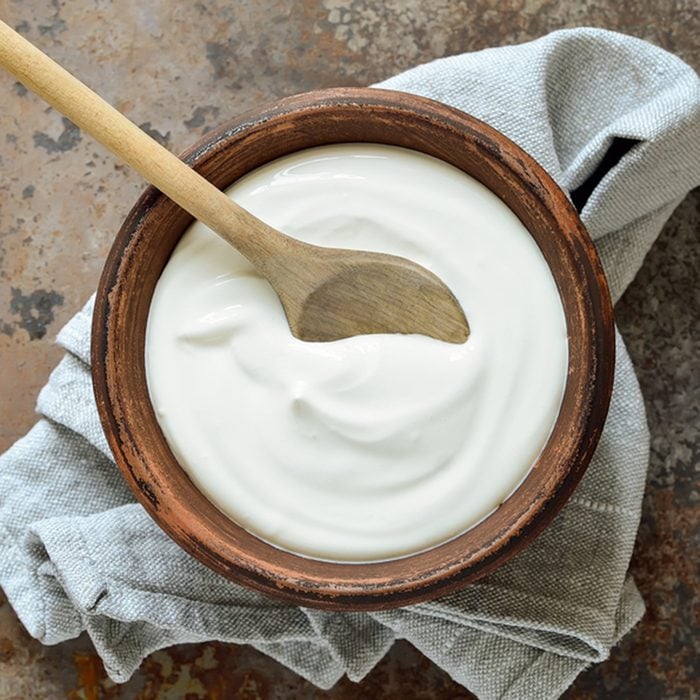 Homemade yogurt or sour cream in a rustic bowl; Shutterstock ID 369768824