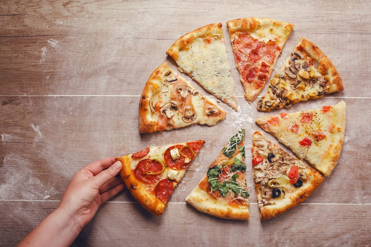 slices of pizza with different toppings on a wooden background