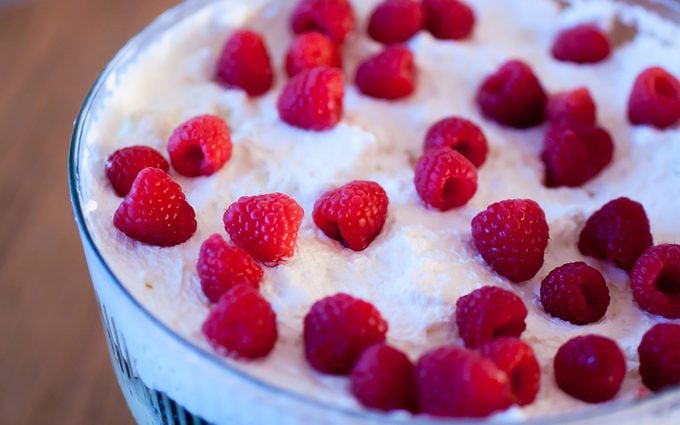 Trifle topped with cream and raspberries - how to make trifle