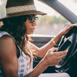 Woman on her phone in the car