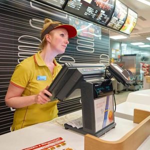 Fast food worker behind the register
